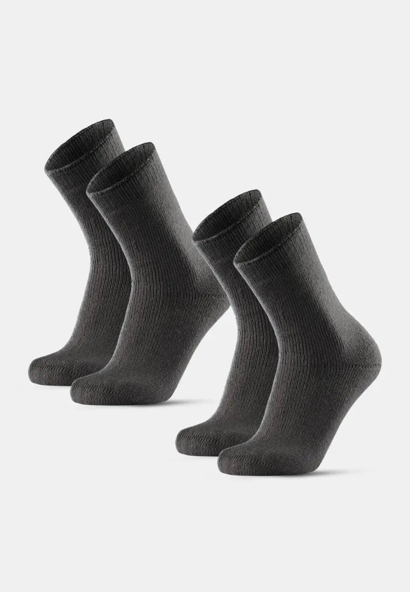 Two pairs of dark gray, ribbed non-slip heat socks, standing upright on a light background.