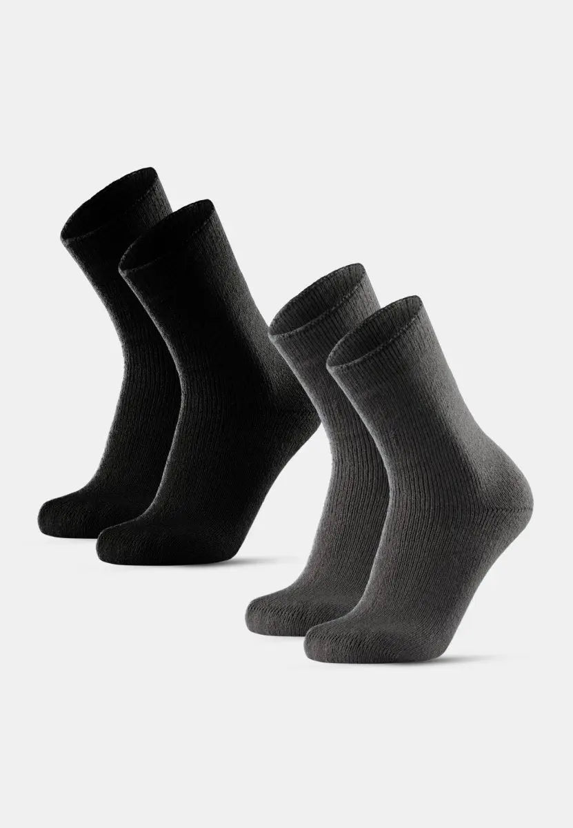 Four non-slip heat socks, two black and two gray, standing upright on a white background.
