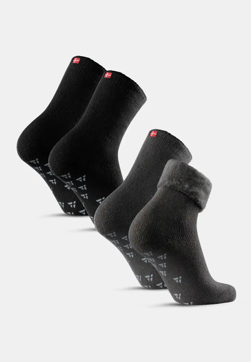 Three pairs of black non-slip socks; two plain, one with a fur cuff, all with a small red tag.