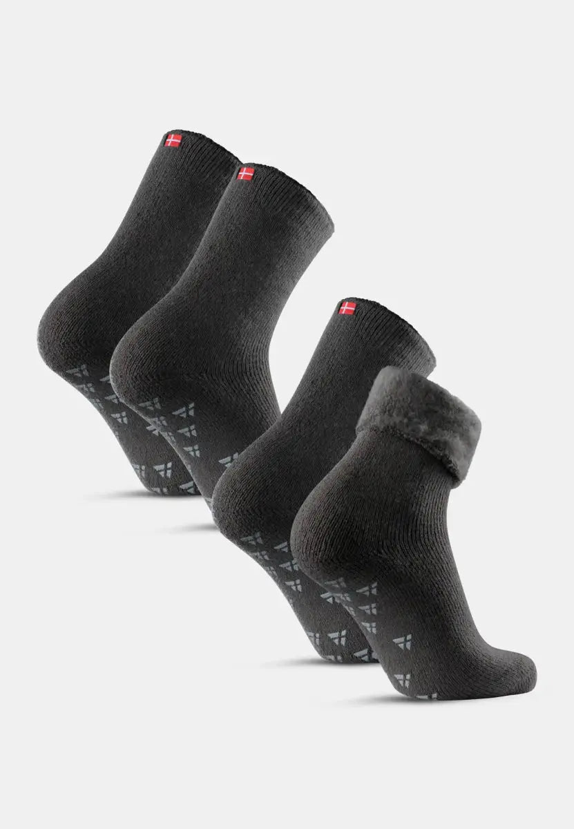 Four dark gray non-slip socks with Danish flag detail, one with a folded cuff.