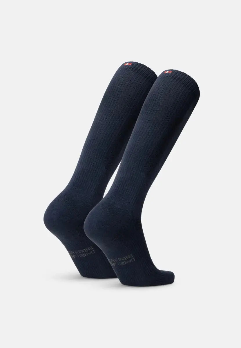 Navy blue organic cotton compression socks standing upright, ribbed texture visible.