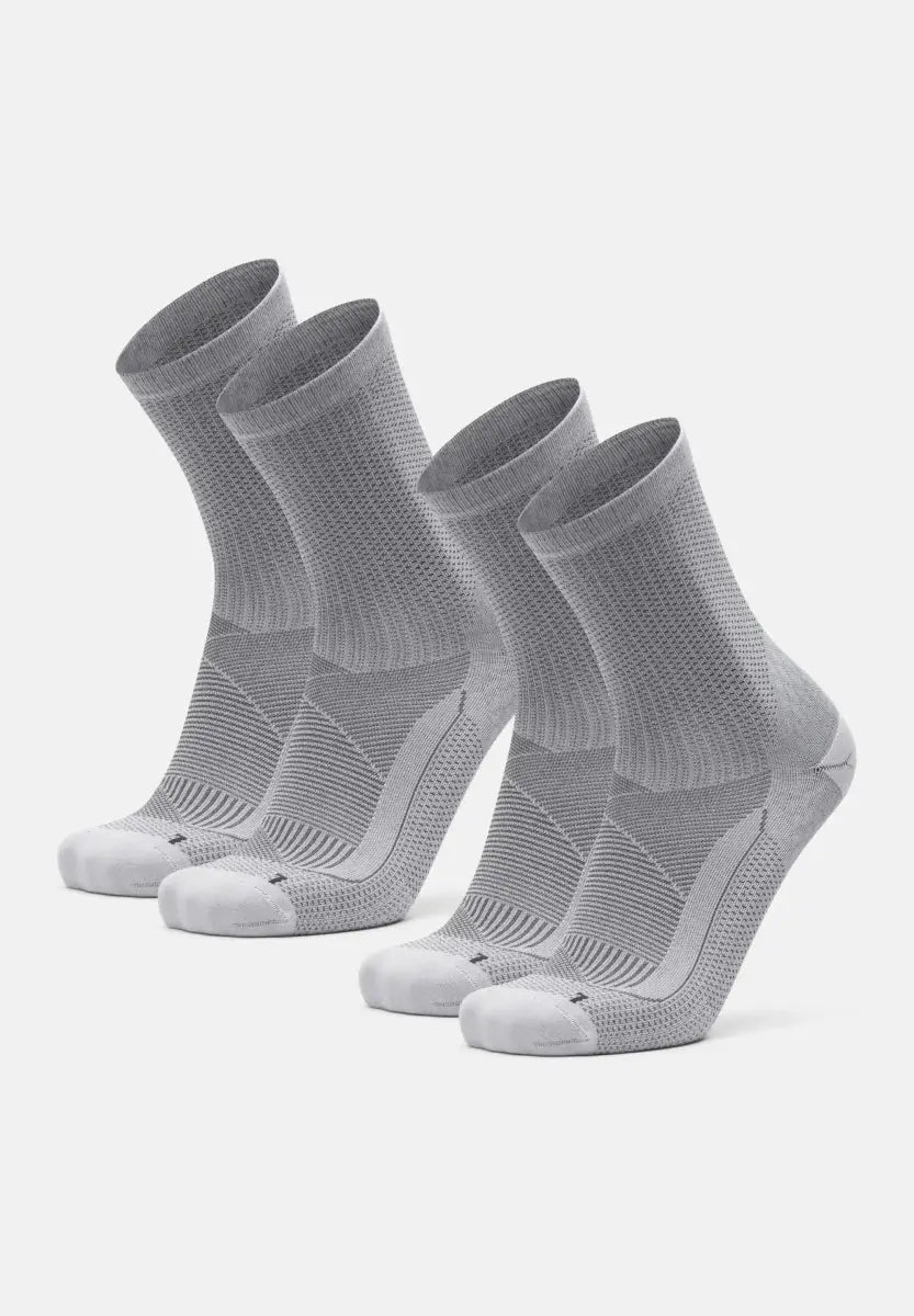 Three pairs of gray compression socks with arch support for plantar fasciitis relief.