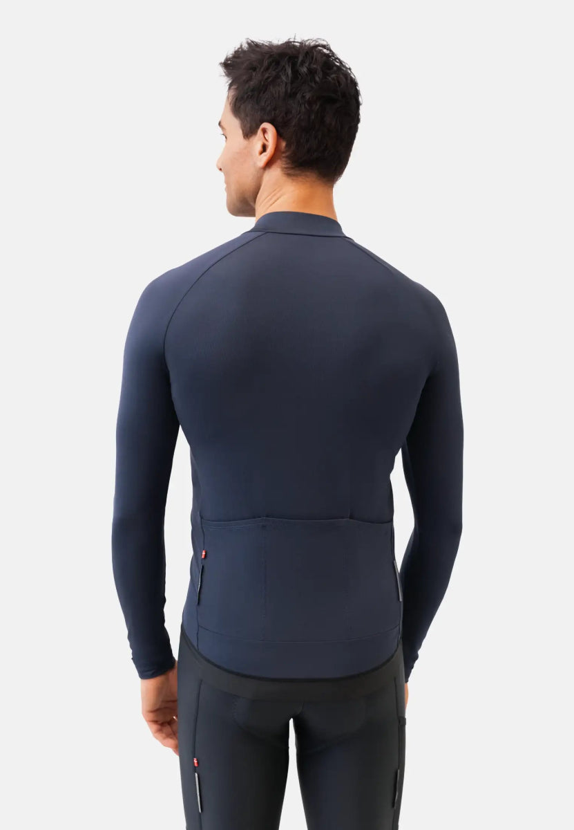 Man from behind in navy long-sleeve cycling jersey, showcasing fit and design.