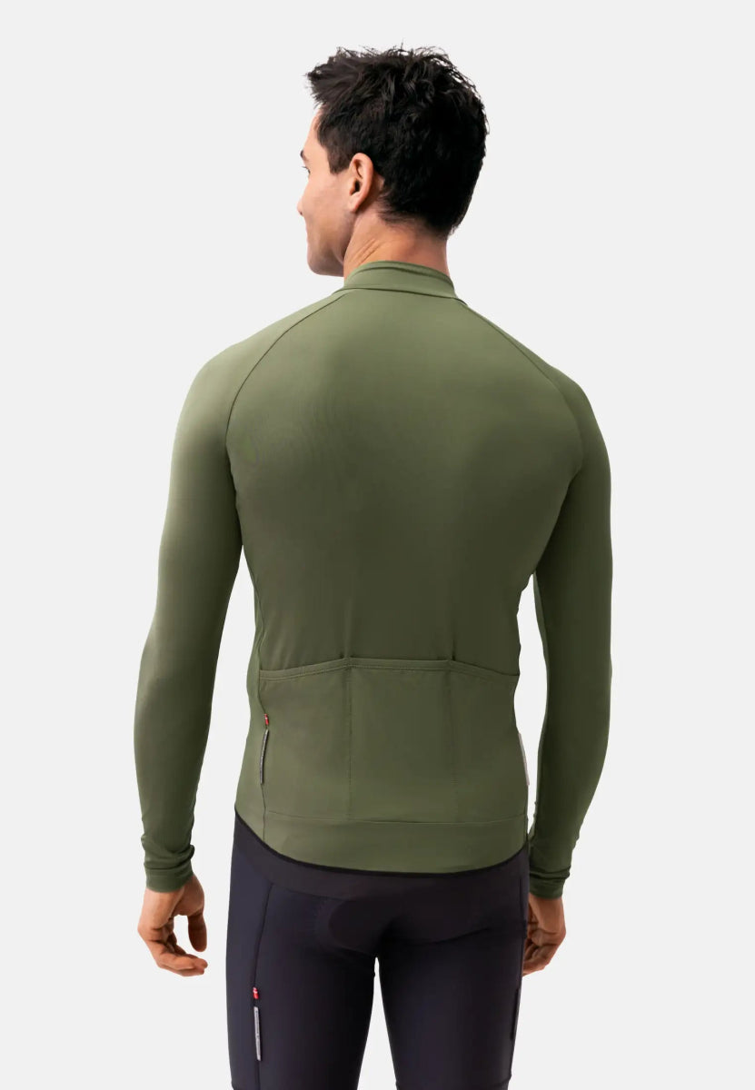 Man in olive green long sleeve cycling jersey, back view, with pockets, against a plain background.