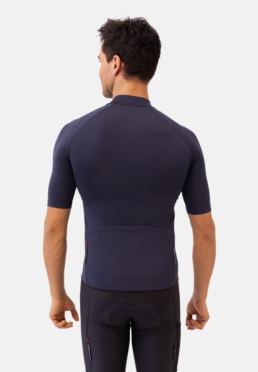 Man from the back in a dark cycling jersey and shorts, highlighting fit and design.