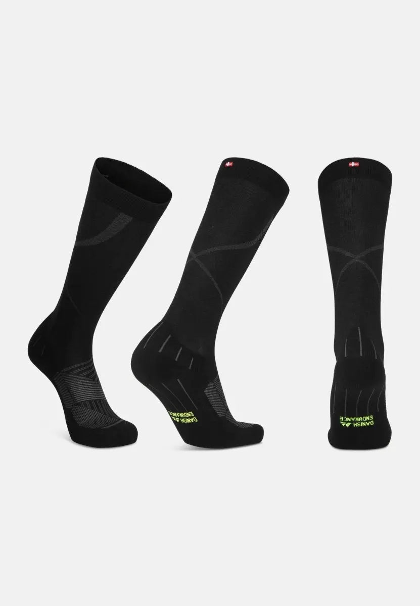 Three black compression socks with subtle patterns and red tags at the top, shown from different angles.