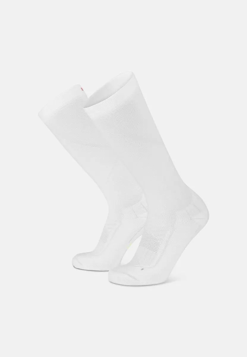 White knee-high compression socks with ribbed detailing, angled view, designed for sports performance.