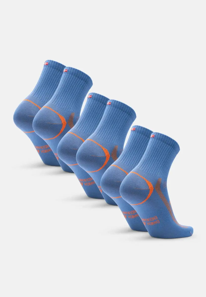 Five blue and orange quarter-length sports socks in a row, showing heel and sole details.