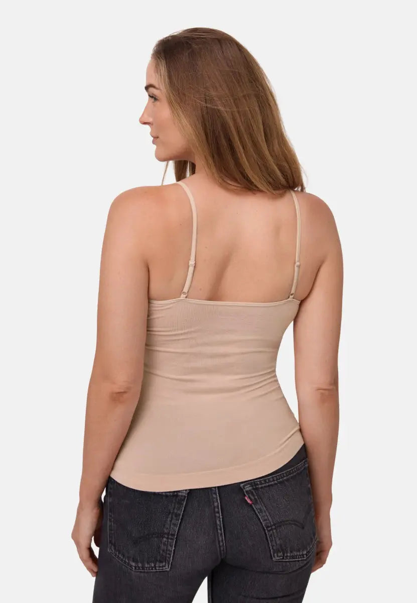 Woman wearing beige seamless bamboo singlet top with thin straps, viewed from the back.