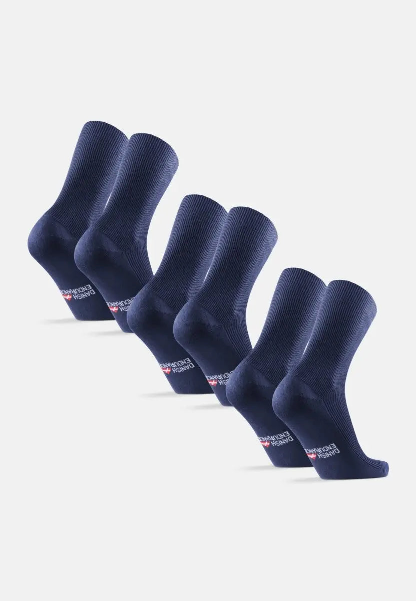 Six pairs of navy blue ribbed crew socks aligned in a row, logo visible on soles.