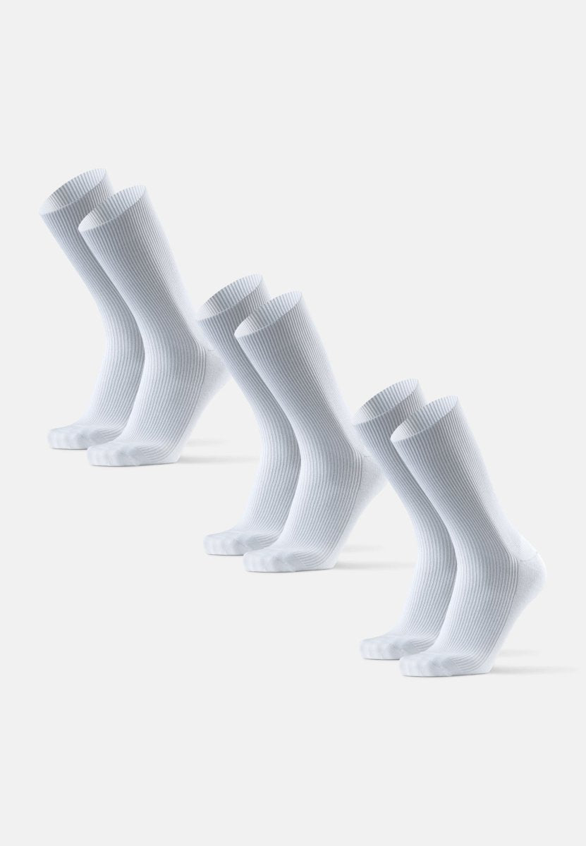 Three pairs of white ribbed crew socks aligned in rows on a light background.