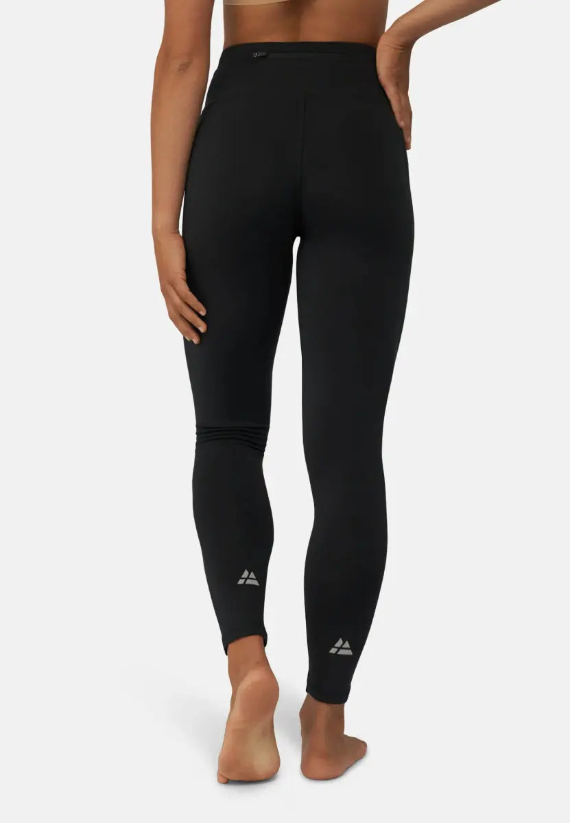 Black sport leggings with a high waist and reflective logos, shown from the back on a model.