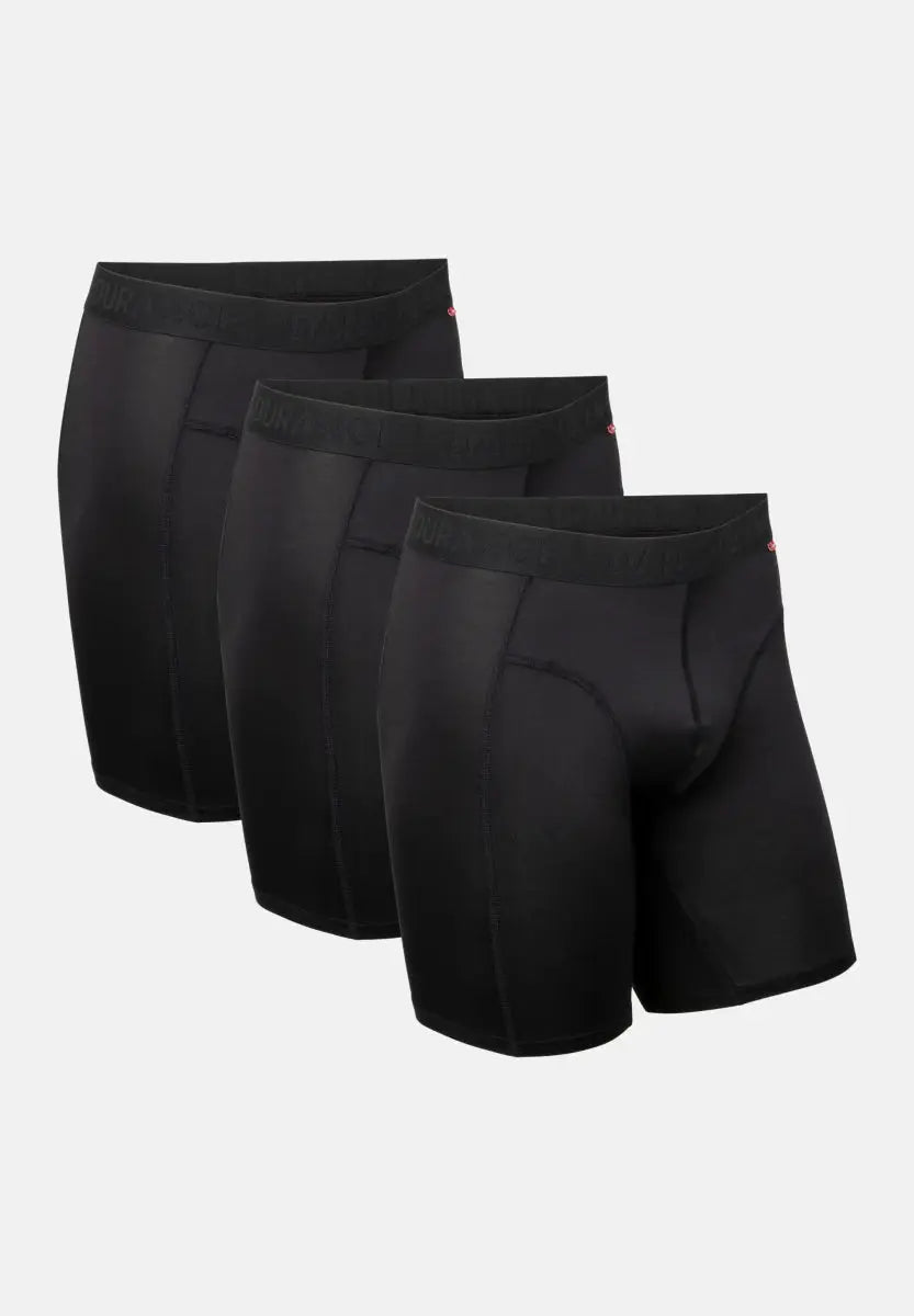 Three pairs of black, extra-long sports boxer shorts with visible waistbands.
