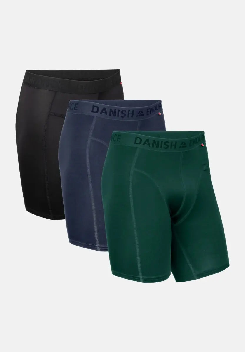 Three pairs of extra-long sports boxer shorts in black, navy, and green with "Danish Endurance" waistbands.