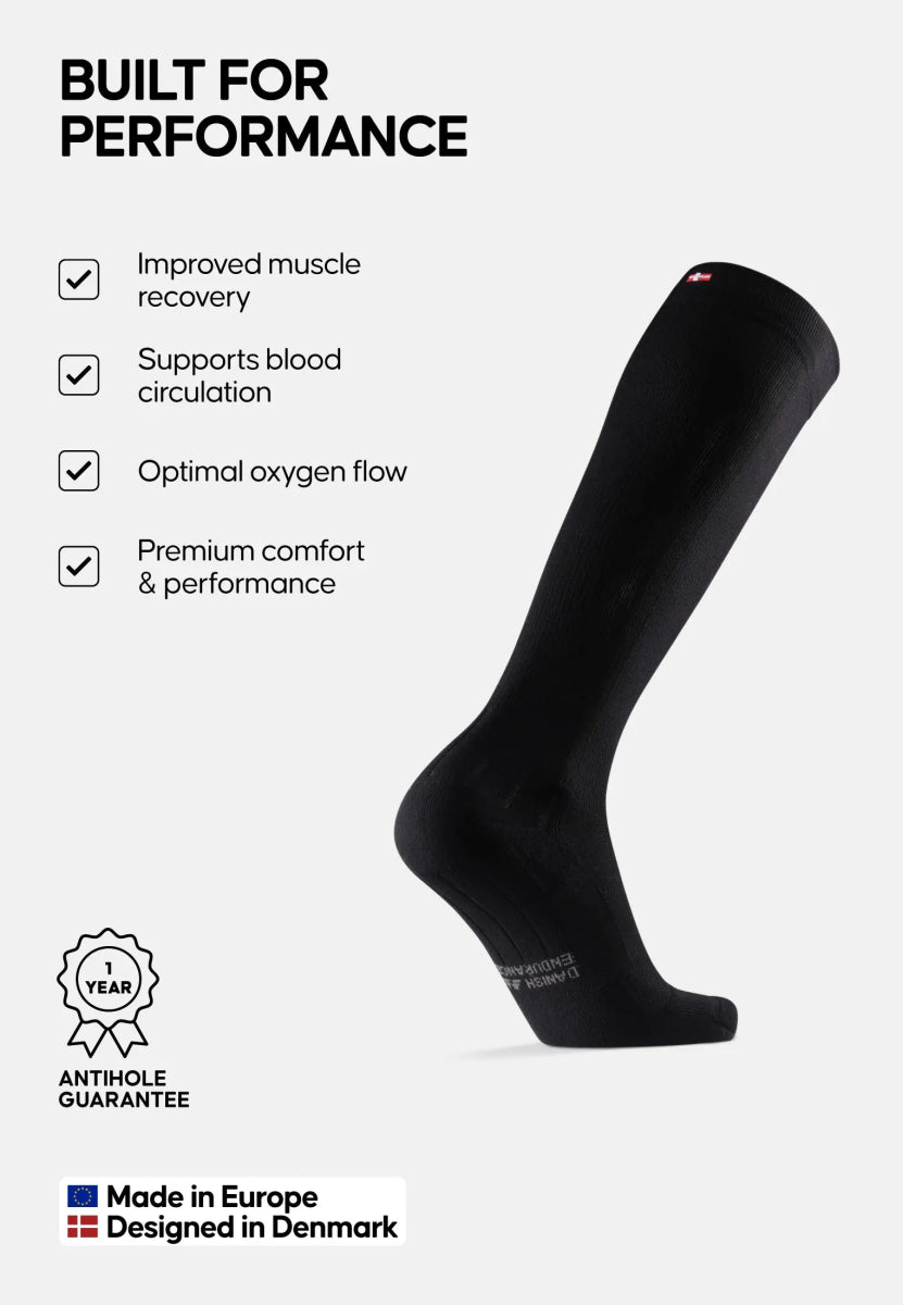 Black compression sock with benefits: muscle recovery, circulation, comfort. Made in Europe, Danish design.