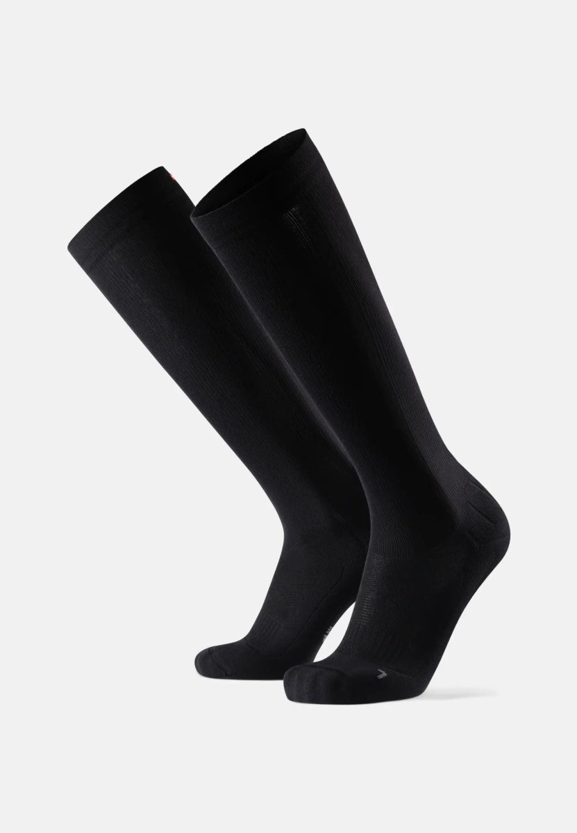 Black knee-high sports compression socks on a white background, angled slightly to the right.