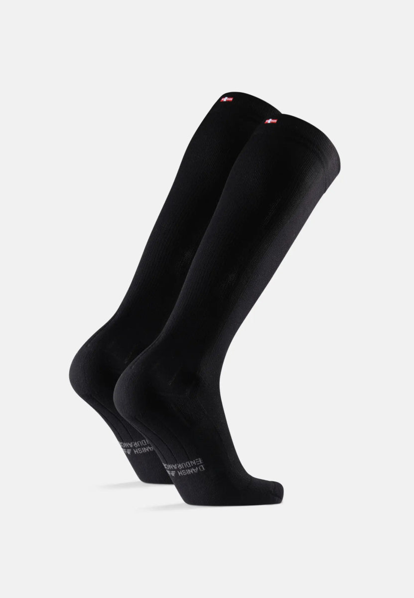 Black knee-high compression socks with logo at top, angled view.