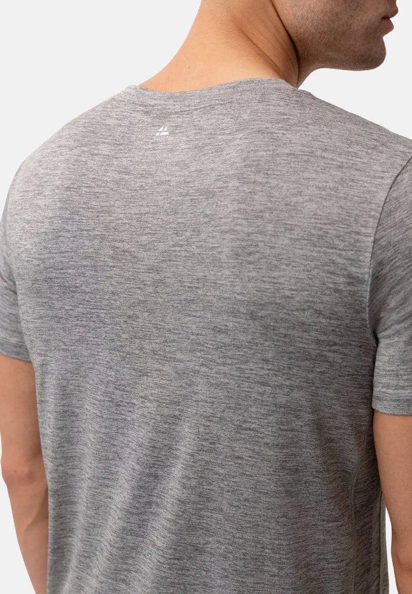 Back view of gray heathered T-shirt with a small logo near the neck, worn by a person.