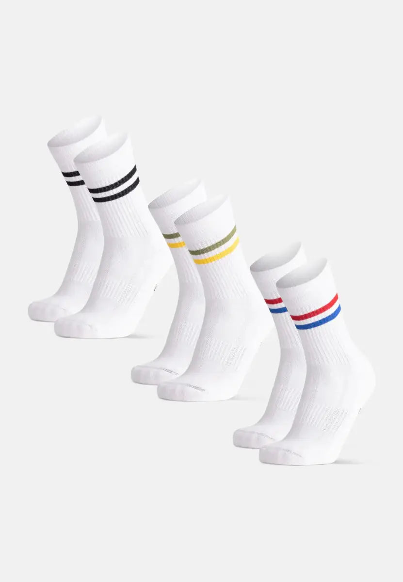 Three pairs of white organic cotton socks with black, olive-yellow, and red-blue stripes.