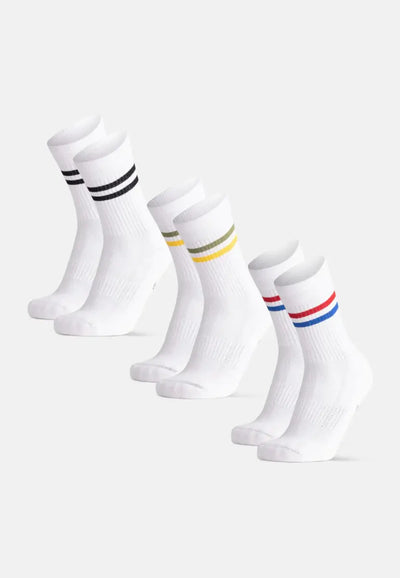 Three pairs of white organic cotton socks with black, olive-yellow, and red-blue stripes.