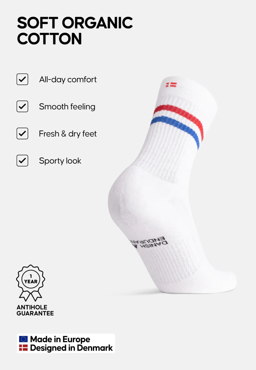 White sock with red, blue stripes; text: "All-day comfort, smooth feeling." Made in Europe.
