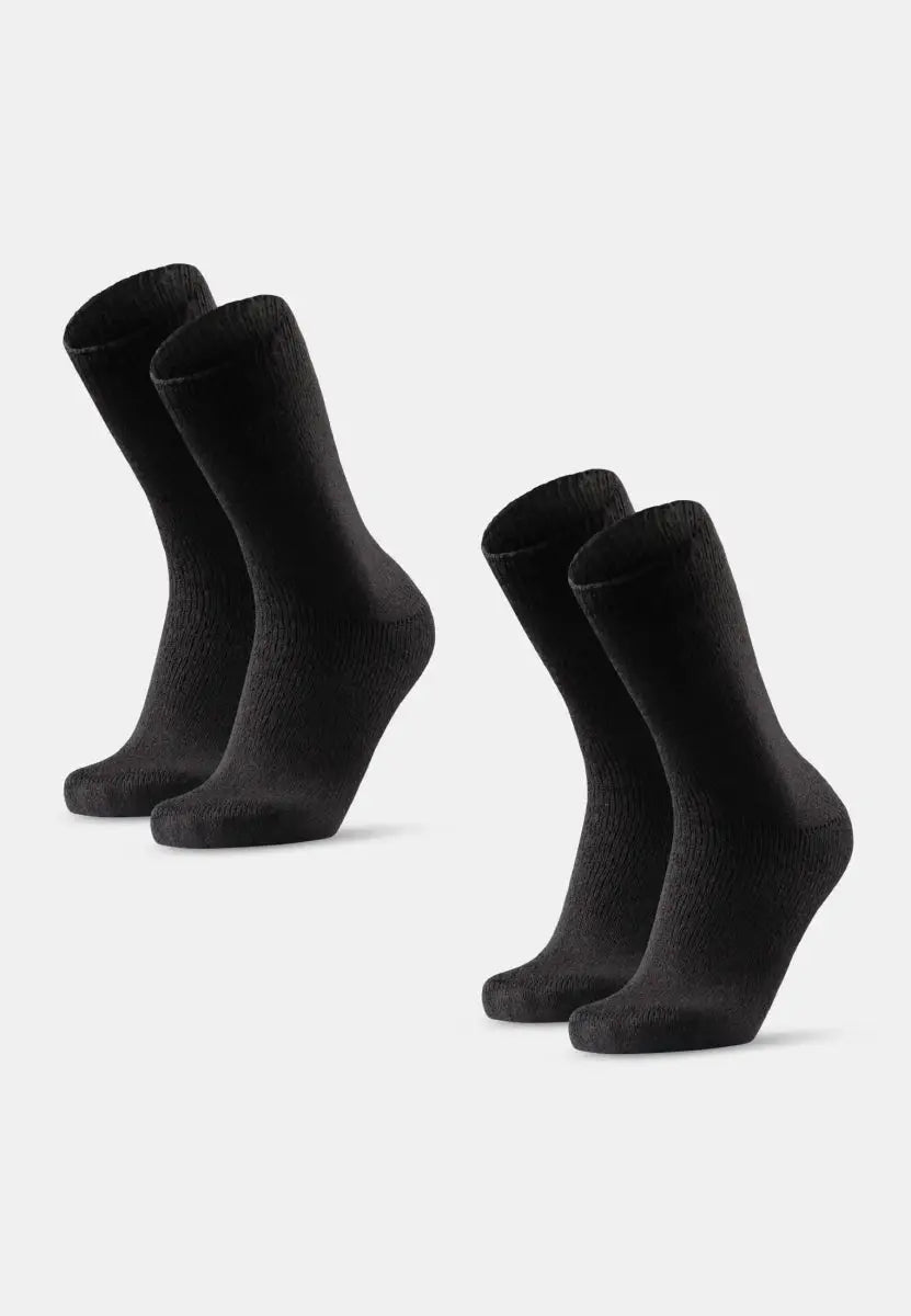 Two pairs of black thermal socks stand upright on a light gray background.