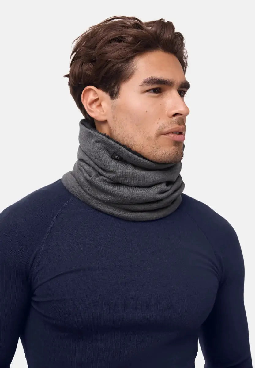 Person wearing a grey merino wool neck gaiter and dark navy top, facing right.
