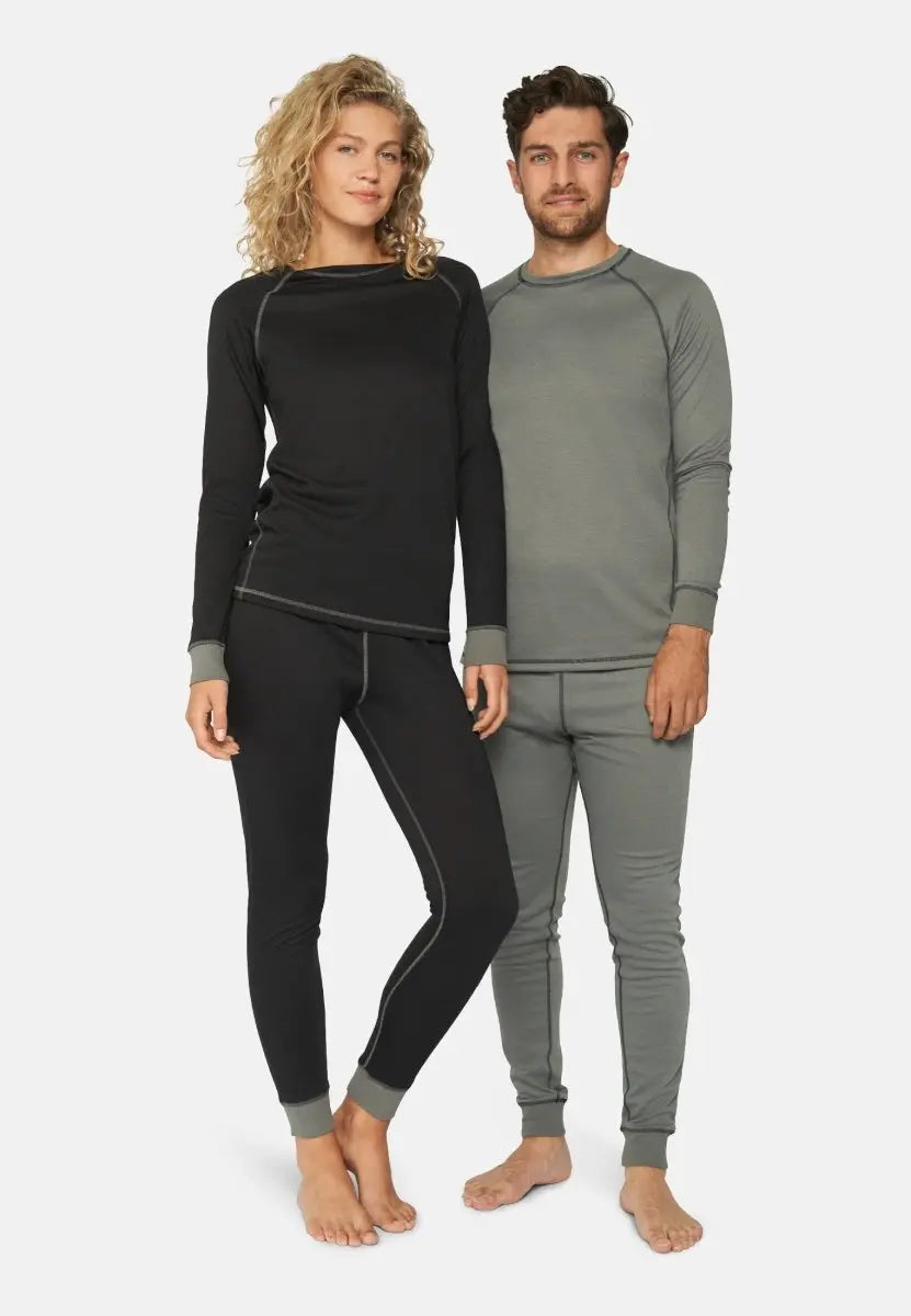 Man in gray and woman in black thermal underwear sets, standing barefoot side by side.