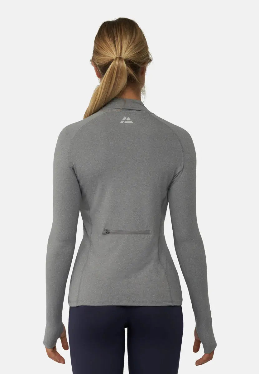 Back view of a woman in a gray athletic shirt with a back pocket, hair in a ponytail.