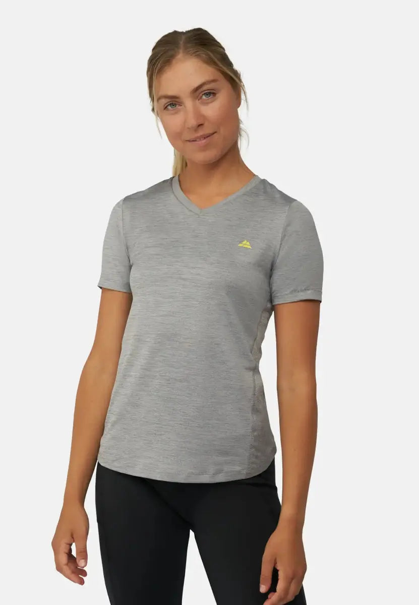 Woman in gray V-neck sports T-shirt with yellow logo, paired with black pants.
