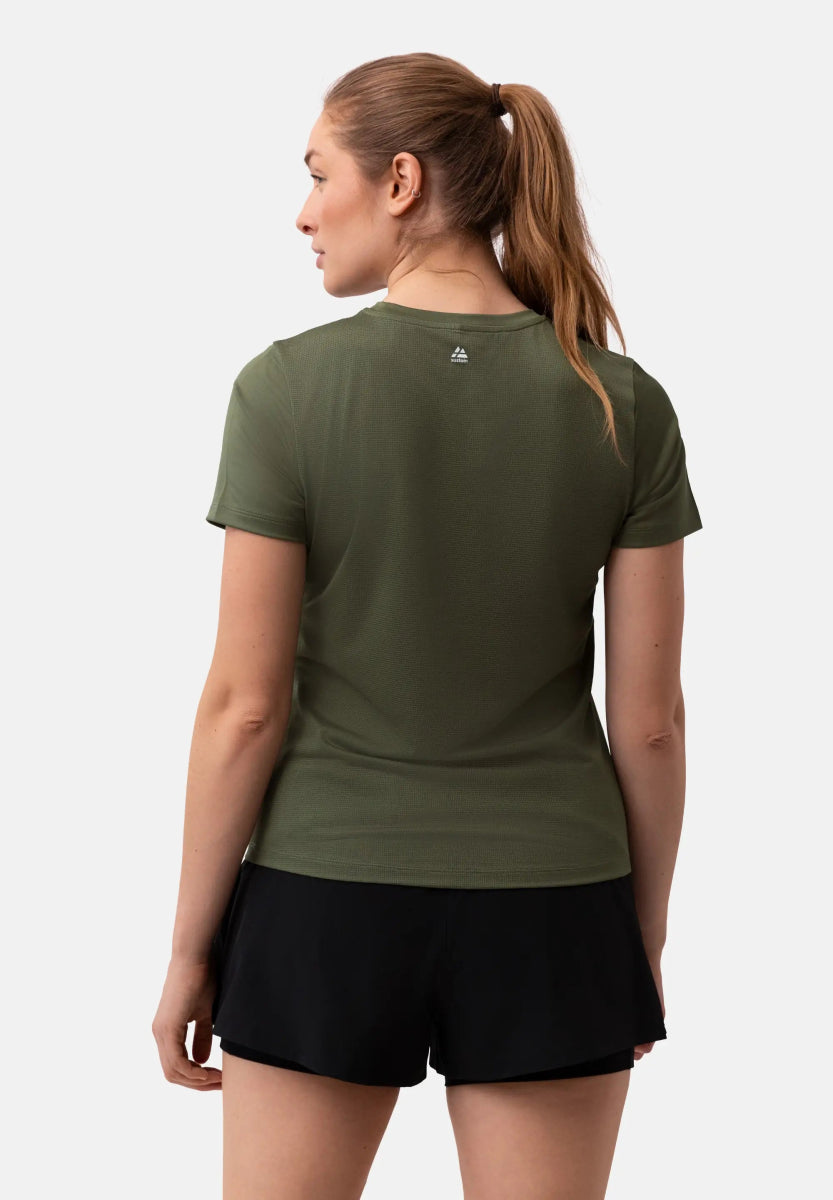 Woman in olive green T-shirt and black shorts, hair in ponytail, viewed from the back.
