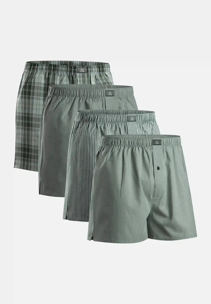Four woven boxer shorts in plaid, solid, and striped patterns, arranged in a cascading display.
