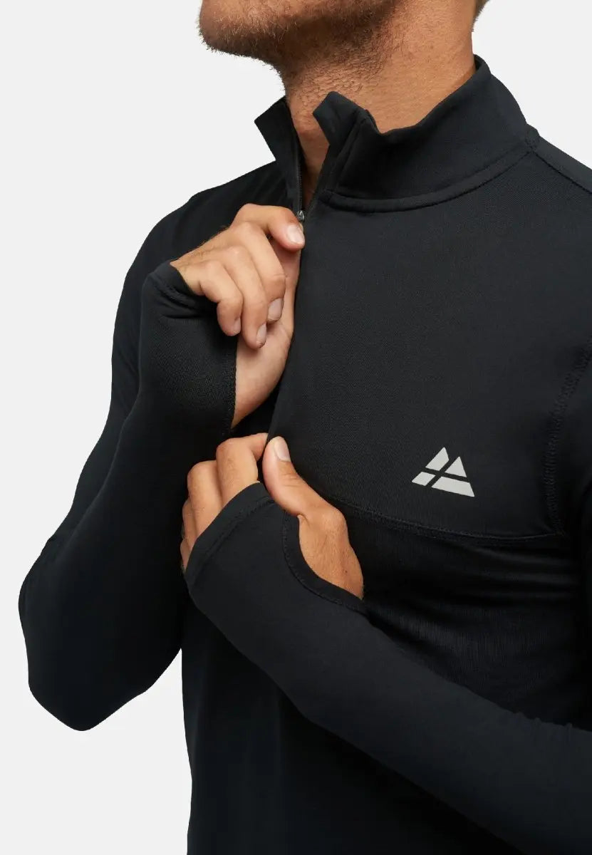 Man in black long-sleeve workout shirt with thumbholes, adjusting collar, logo visible.
