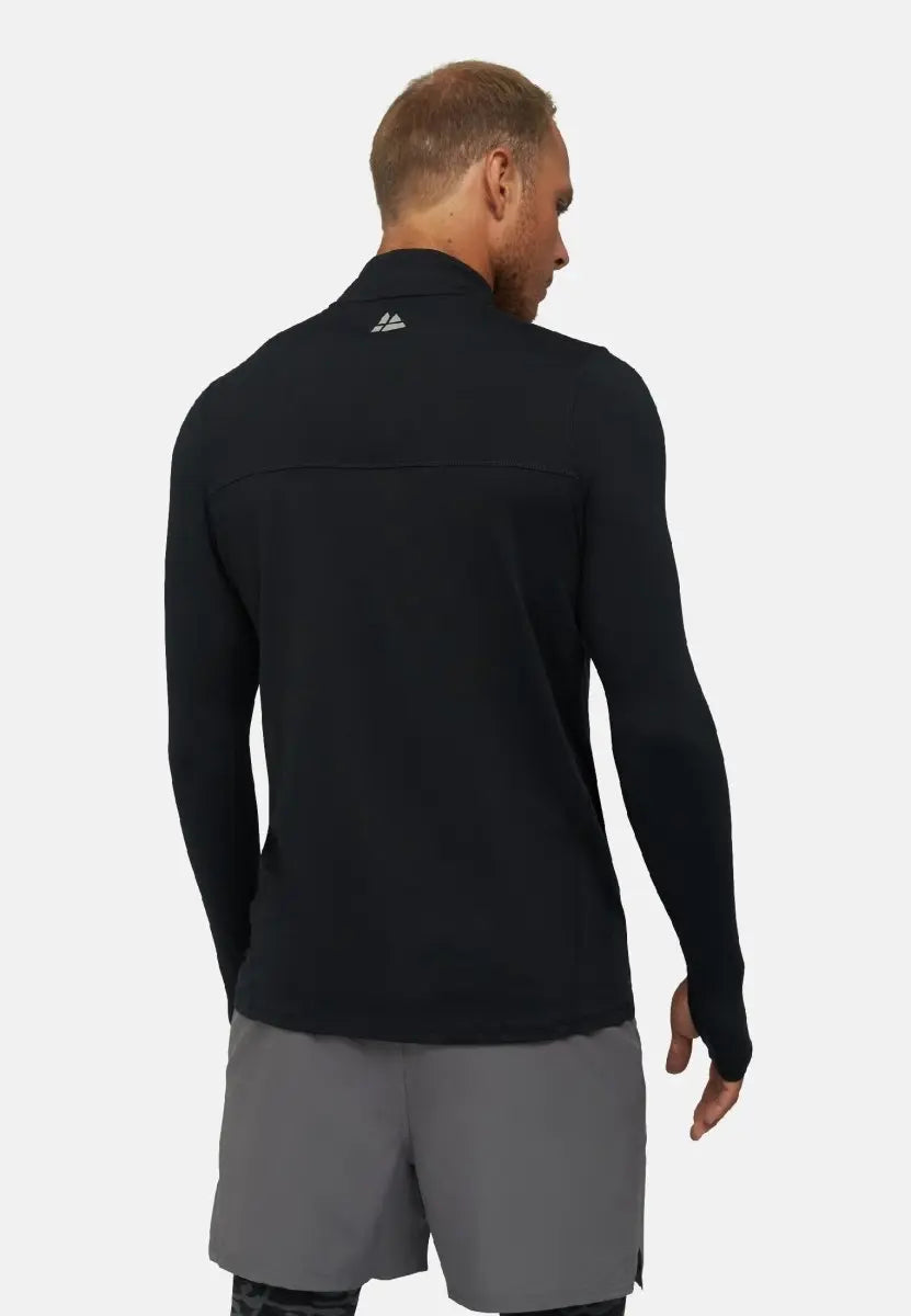 Man in black long sleeve workout shirt and gray shorts, viewed from the back.