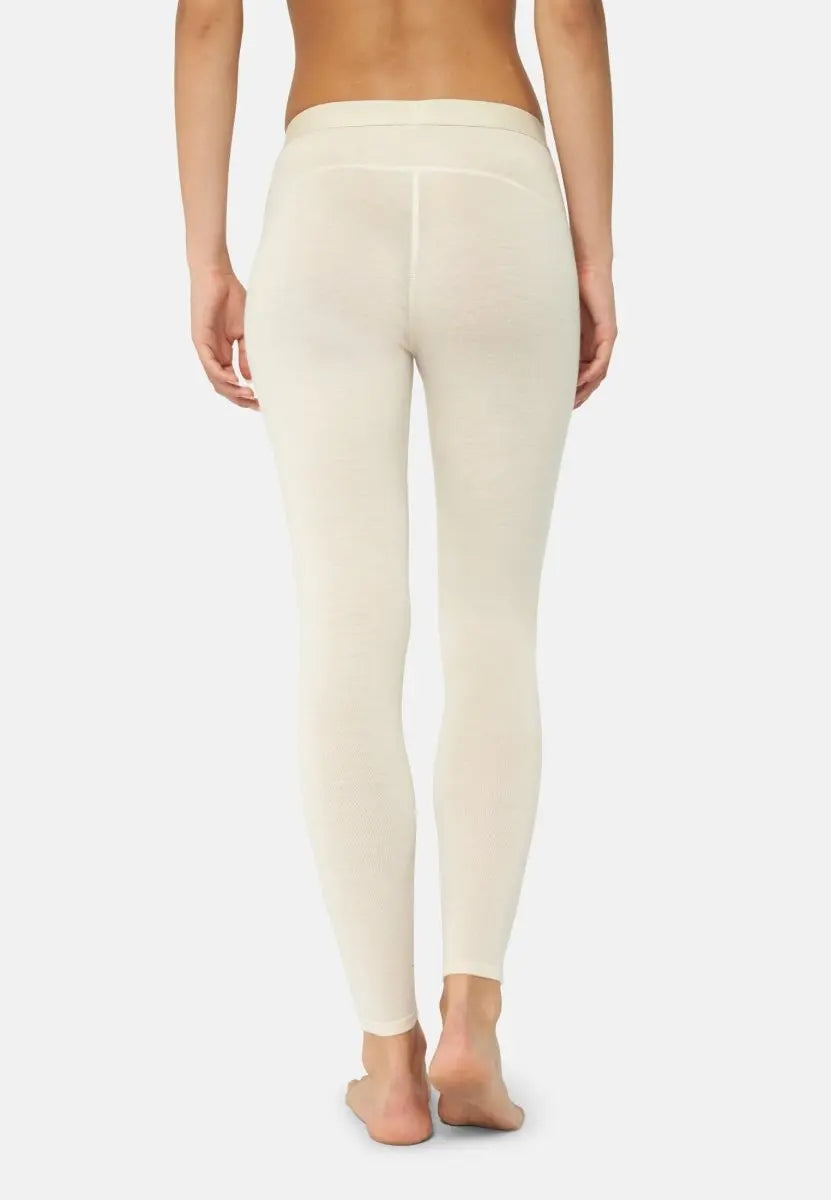 Back view of cream merino wool base layer pants for women, showcasing fit and texture.