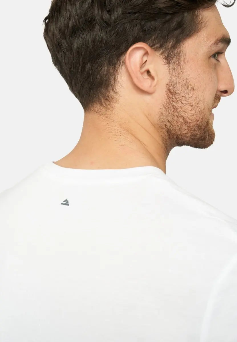 Back view of a man wearing a white crew neck t-shirt with a small triangular logo near the neckline.
