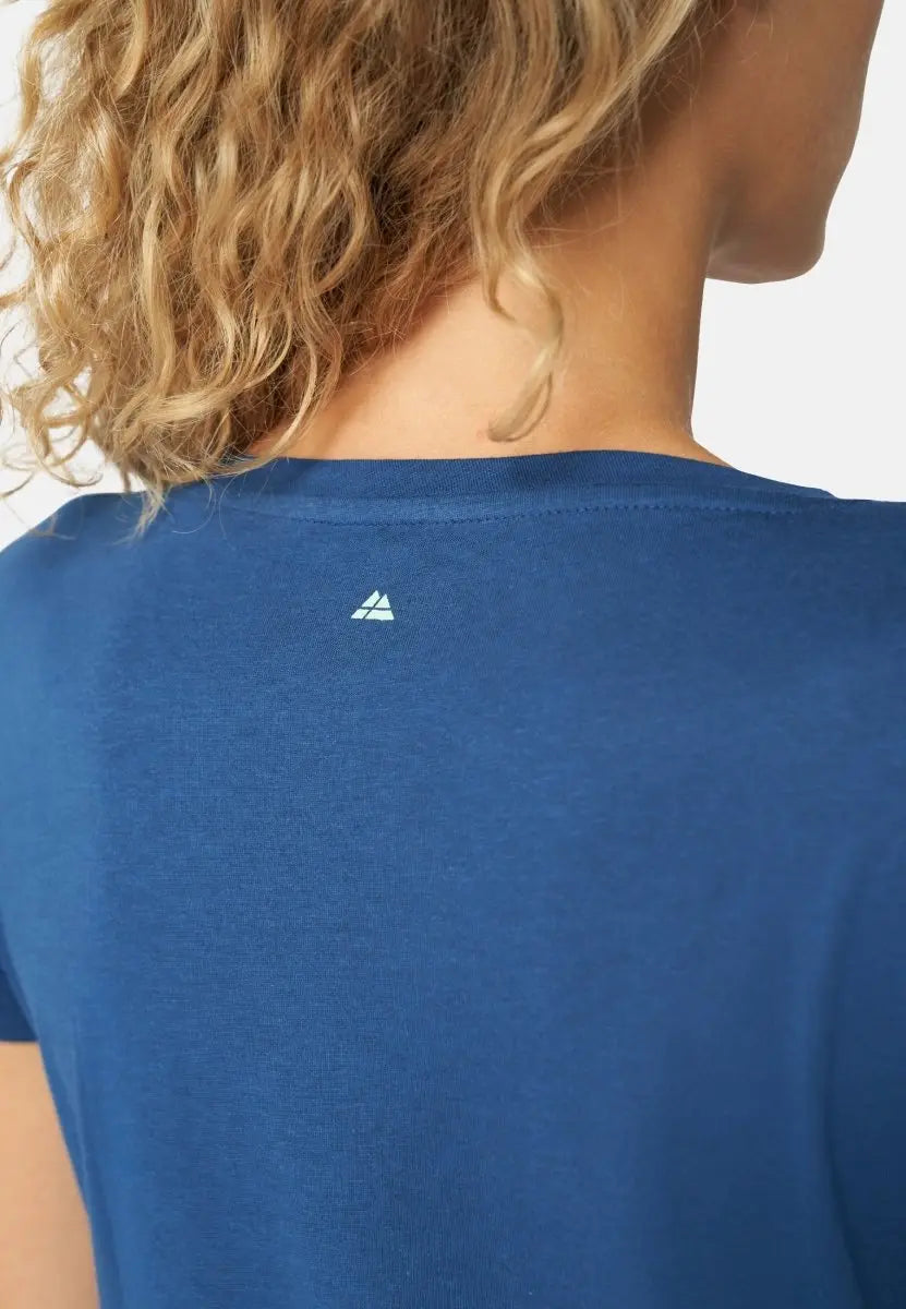 Back view of a blue crew neck T-shirt with a small white logo below the neck.