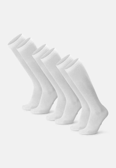 Five pairs of white knee-high organic cotton compression socks aligned in a row.
