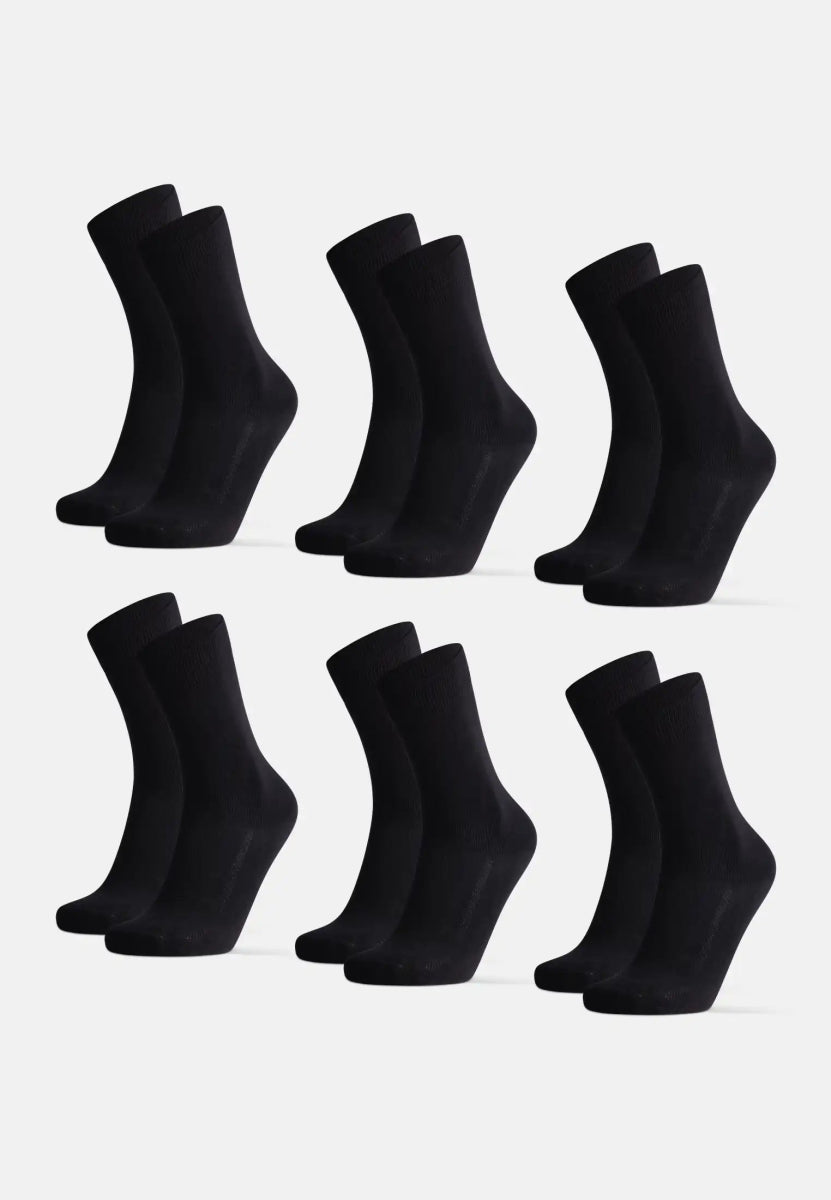 Six pairs of black organic cotton dress socks, neatly arranged on a white background.