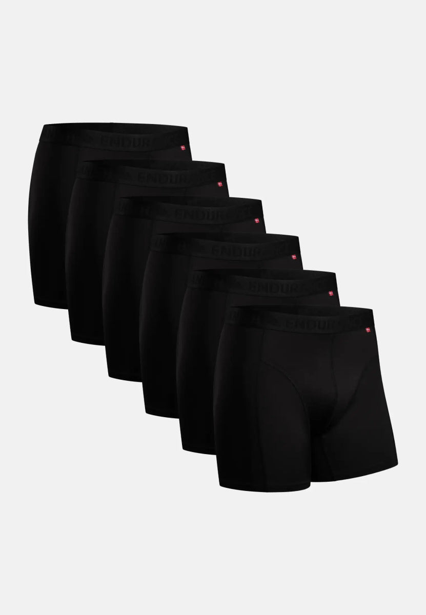 Six black sports boxer shorts with logo on waistband, displayed in a row.